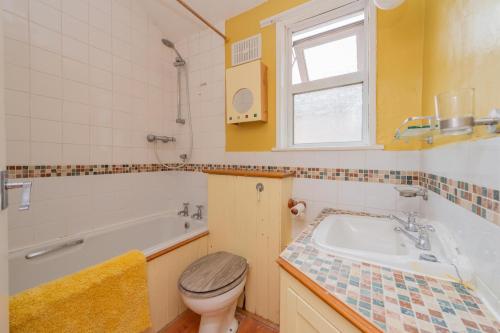 a bathroom with a sink and a toilet and a tub at Monet's in Telford