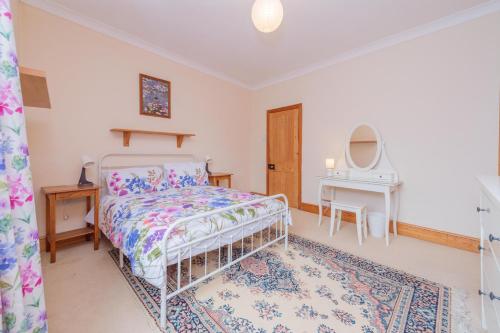 a bedroom with a bed and a table at Monet's in Telford