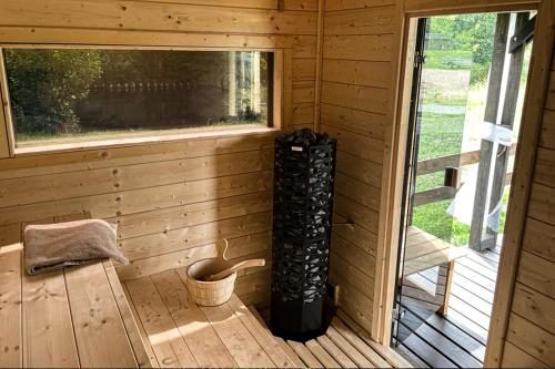 a inside of a wooden cabin with a window at Szept Oberlandu - boutique, luxury Villa in Liva Park in Liwa