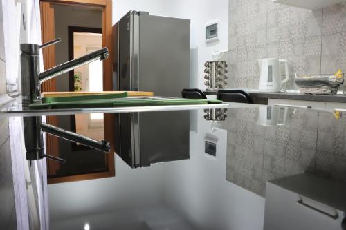 a kitchen with a stainless steel counter top at Miko Apartment by Quokka 360 - flat in Legnano in Legnano