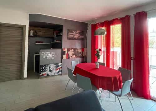 a dining room with a red table and chairs at La Primula by Quokka 360 - flat outside the city of Como in Tavernerio