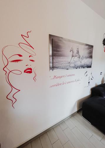 a wall with a painting of a woman and a horse at La Primula by Quokka 360 - flat outside the city of Como in Tavernerio