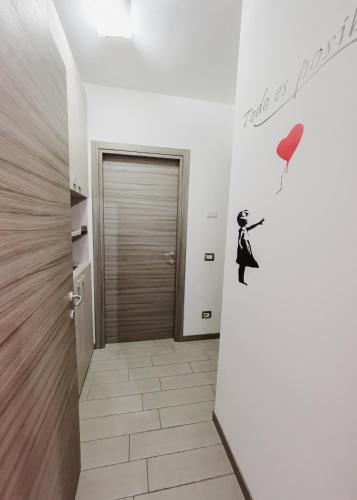 a hallway with a door with a man with a balloon at La Primula by Quokka 360 - flat outside the city of Como in Tavernerio