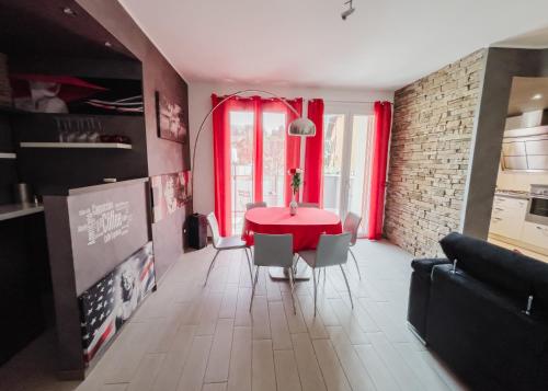 a living room with a red table and chairs at La Primula by Quokka 360 - flat outside the city of Como in Tavernerio