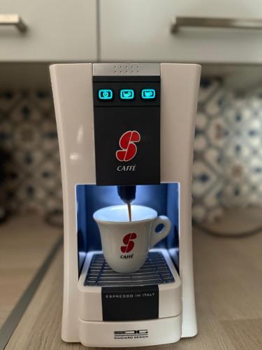 a coffee machine with a cup on top of it at Seaside Apartment in Salamís