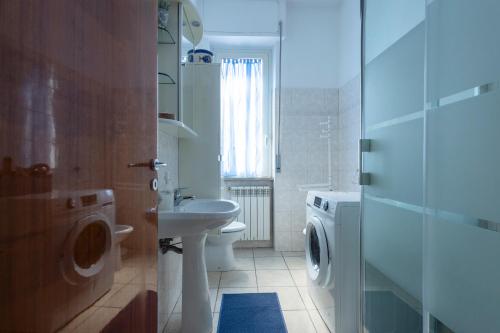 a bathroom with a toilet sink and a washing machine at Da Grazia in Pescara
