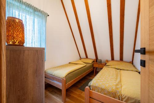 a small room with two beds and a window at Vila Sun forest in Žabljak