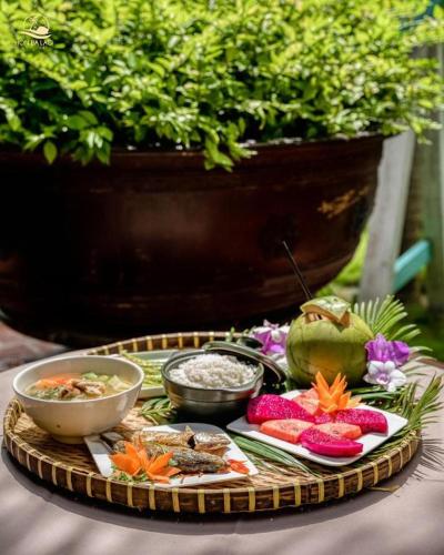 a tray of food on a table with bowls of food at HON BA LAGI BEACH RESORT in La Gi