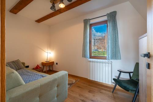 a living room with a couch and a window at Vila Sun forest in Žabljak
