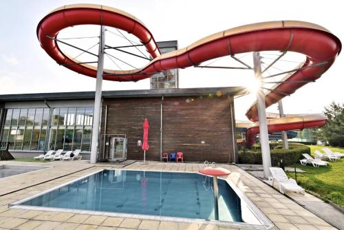 a pool with a slide and a swimming pool at FamilyVilla, new 4 Luxury Big Apartments, parking in Prague