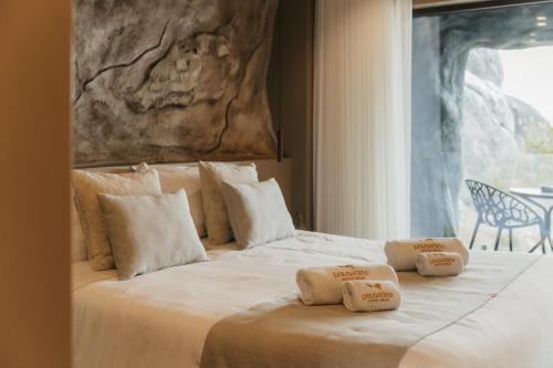a bedroom with a bed with two pillows on it at Pousadela Village & Spa in Vieira do Minho