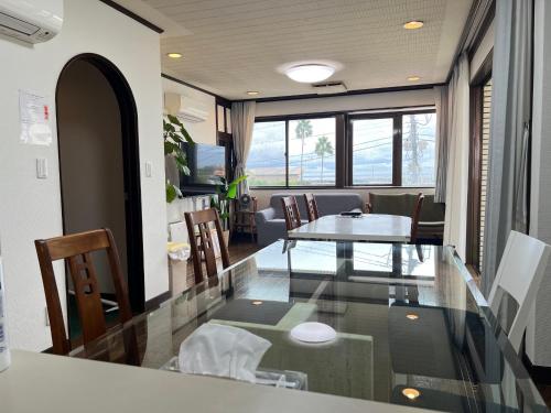 a living room with a table and chairs at Marina Bay Atami in Atami