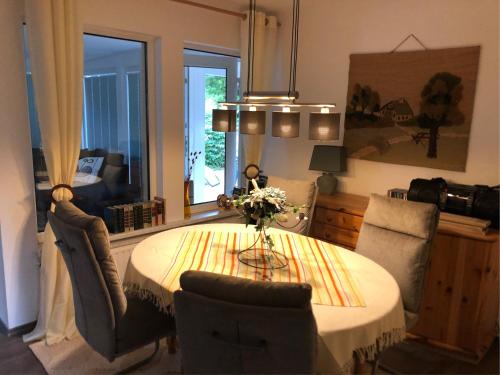 a dining room with a table and two chairs at Ferienhaus Am Eichenberg Haus 3 in Blankenburg