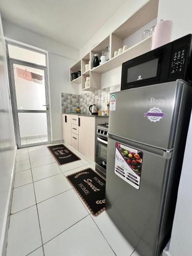 a kitchen with a stainless steel refrigerator at Majestic Homes - HER MAJESTY in Mombasa