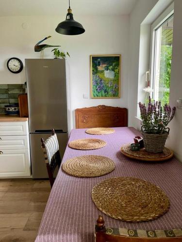 a kitchen with a table with five plates on it at Klimatyczny Dom z widokiem na Babią Górę in Maków Podhalański