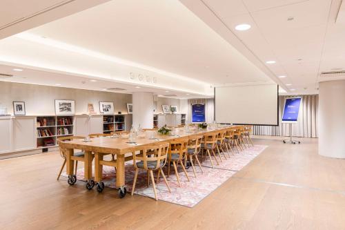 a conference room with a long table and a whiteboard at Radisson Blu Seaside Hotel, Helsinki in Helsinki