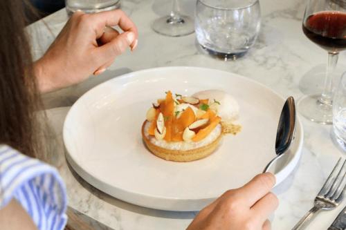 a person sitting at a table with a plate of food at Kyriad Vannes Centre Ville in Vannes