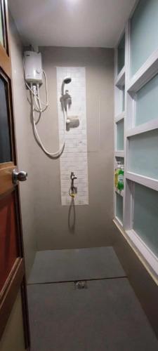 a bathroom with a shower in a room at Eyy Hostel in El Nido
