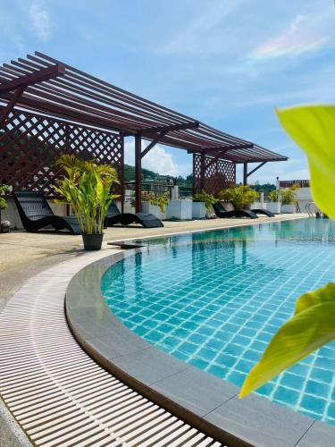 a swimming pool with a pavilion on top of a building at Blue Skyline Hotel in Patong Beach