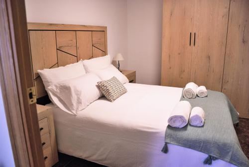 a bedroom with a bed with two slippers on it at Can Teixidó in Arbeca