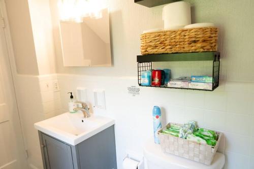 a bathroom with a sink and a toilet at Charming & Cozy 3BR home mins to SU-ESF-Upstate-Le Moyne in Syracuse