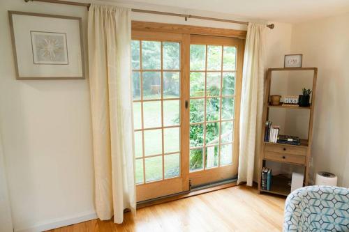 a room with a large door and a window at Charming & Cozy 3BR home mins to SU-ESF-Upstate-Le Moyne in Syracuse
