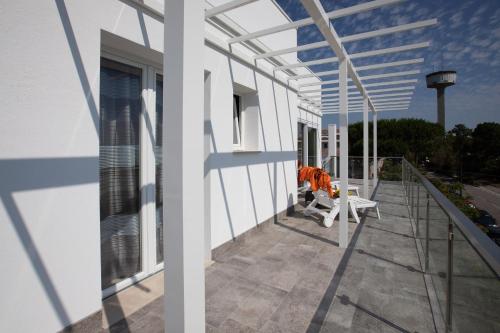 a balcony of a house with a bench on it at Elsa Attico vista mare in Rosolina Mare