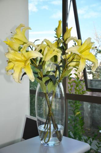 a vase filled with yellow flowers sitting on a table at Hotel Del Rio in Constitución