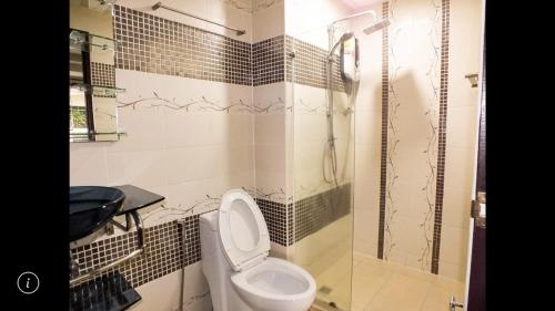 a bathroom with a toilet and a shower at Junior apartment in Pattaya