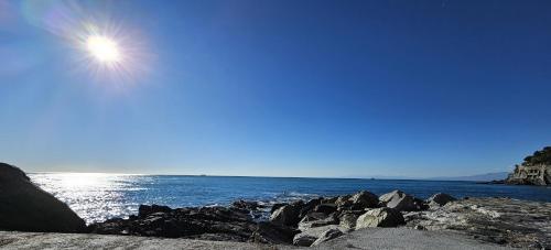 a view of the ocean from a rocky beach at Bogliasco La Fontana Home in Bogliasco