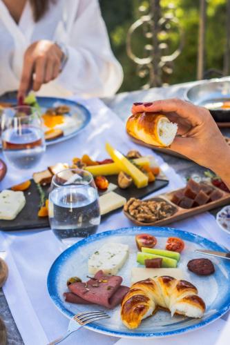 a table with plates of food on top of it at Cappadocia Gamirasu Cave Hotel in Urgup
