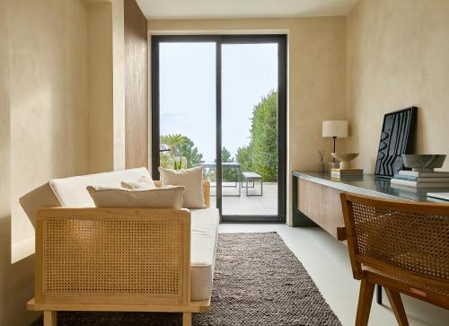 a living room with a white couch and a desk at The Cliff By DKollection in Brighton & Hove