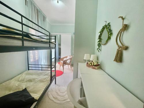 a bedroom with a bunk bed and a desk in a room at Appartamento Giulio in Cannobio