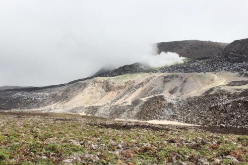 a mountain eruption with steam coming out of it at Hotel Albemarle Galapagos Beachfront in Puerto Villamil