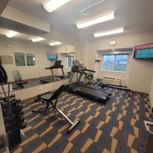 a gym with treadmills and exercise bikes in a room at Microtel Inn & Suites Sault Ste. Marie in Sault Ste. Marie