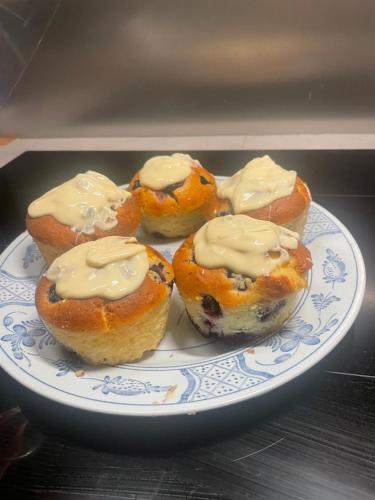 a plate of muffins with cream cheese on it at B&B Eco Chalet Merlet in Champoluc
