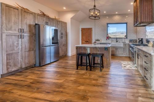 a kitchen with wooden cabinets and a stainless steel refrigerator at Double MM Ranch in Emigrant