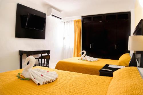 Una cama o camas en una habitación de Hotel Antillano