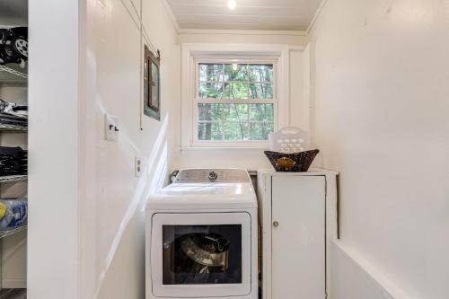 a laundry room with a stove and a window at Family-Friendly Knoxville Home Close to UT! in Knoxville