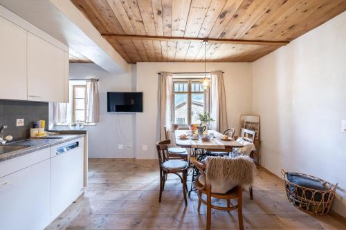 a kitchen and dining room with a table and chairs at Ustarea Spluga in Ardez