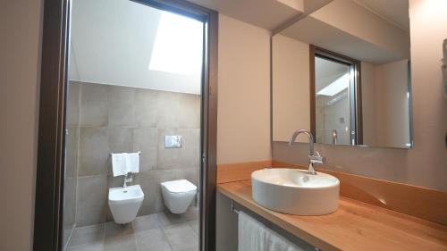 a bathroom with a sink and a toilet at Hotel Europa in Reggio Emilia