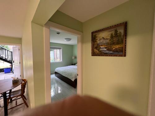 a bedroom with a bed and a painting on the wall at Newton B&B in Surrey