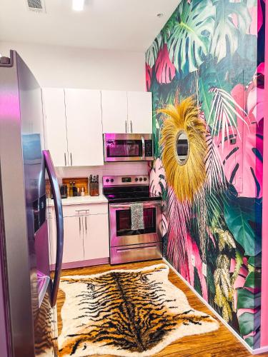 a kitchen with a painting on the wall at Dreaming With Dolly - Luxe Stay Near Broadway in Nashville