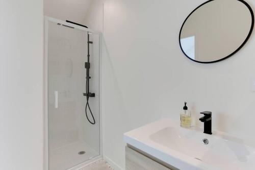 a white bathroom with a shower and a mirror at Maison Joseph - Chambre 1 in Saint-Jacques-de-la-Lande