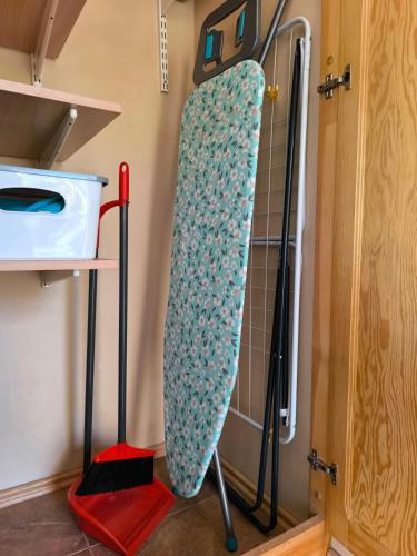 a kitchen with a refrigerator and a shelf with a door at Flip-Flops Apartment Jurmala with free parking in Jūrmala