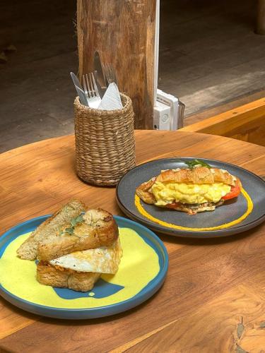 two plates of breakfast food on a wooden table at Sky Breeze in Unawatuna