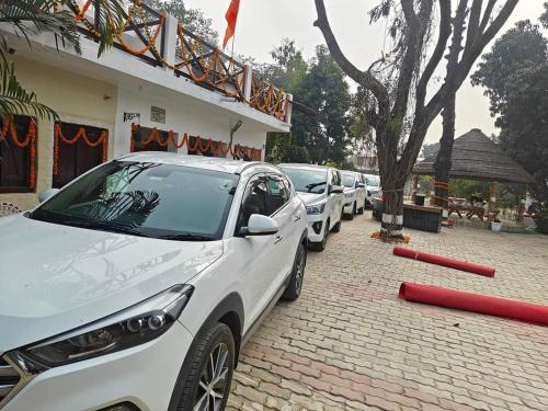 a row of cars parked in front of a building at Shobhayan inn, airport railway station pickup free in Ayodhya