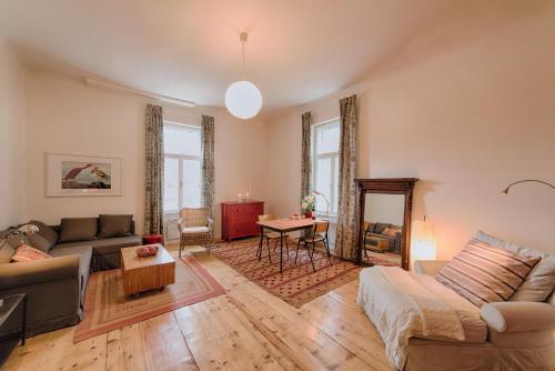 a living room with a couch and a table at Landhaus Blauer Spatz Reichenau an der Rax in Reichenau