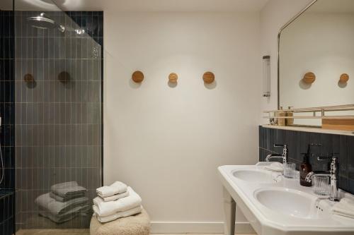 a bathroom with a sink and a shower at La Closerie des Capucines in Arbois