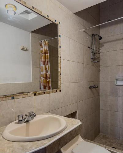a bathroom with a sink and a mirror at Casa Huaca in Lima